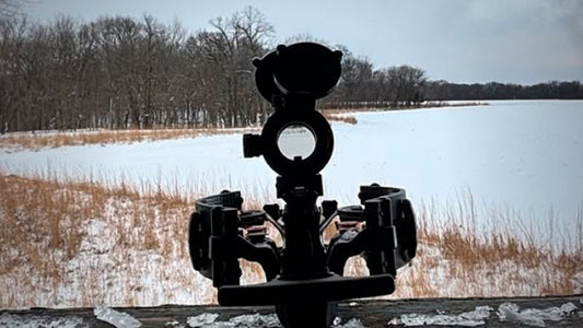 Crossbow overlooking a snowy field during a cold-weather hunt