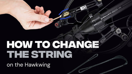 Close-up of the Ballista Hawkwing's cam during a crossbow string change, with the fresh replacement string laid out
